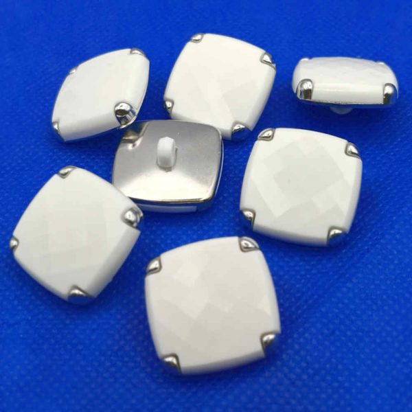 White faceted coat buttons