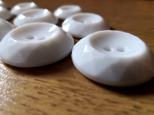 White faceted buttons